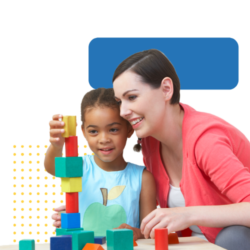 Behavioral technician and a child playing with wooden blocks together